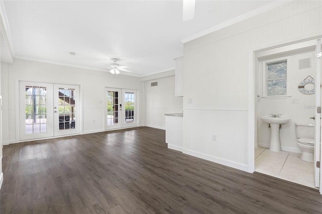 unfurnished living room featuring sink, dark hardwood / wood-style flooring, ornamental molding, ceiling fan, and french doors