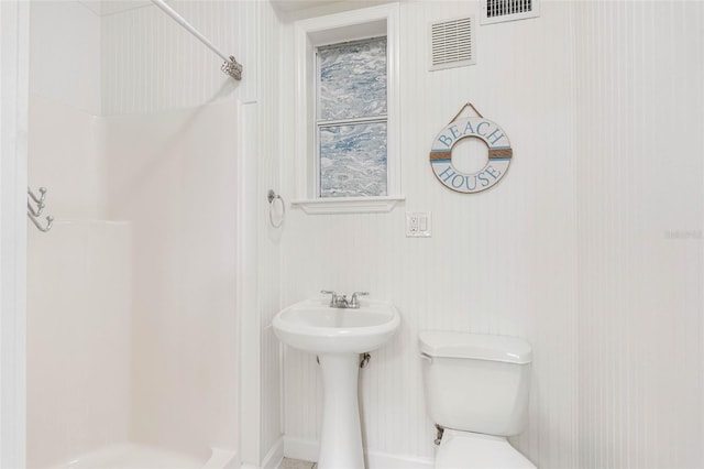 bathroom with toilet and a shower