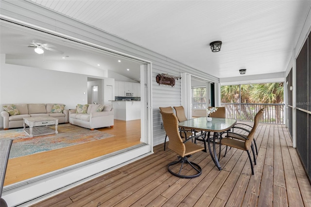 sunroom / solarium with lofted ceiling and ceiling fan