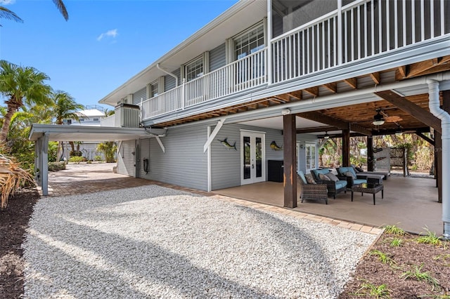 back of property with an outdoor hangout area, ceiling fan, and a patio area