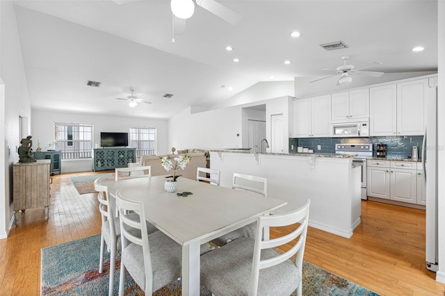 dining area with recessed lighting, visible vents, light wood-style floors, vaulted ceiling, and ceiling fan