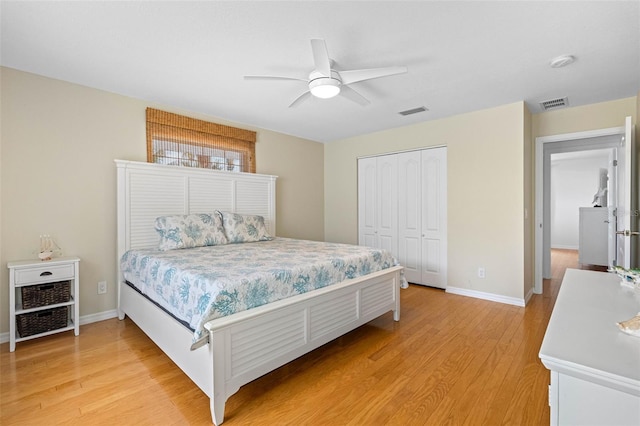 bedroom featuring light wood-type flooring, a closet, and visible vents