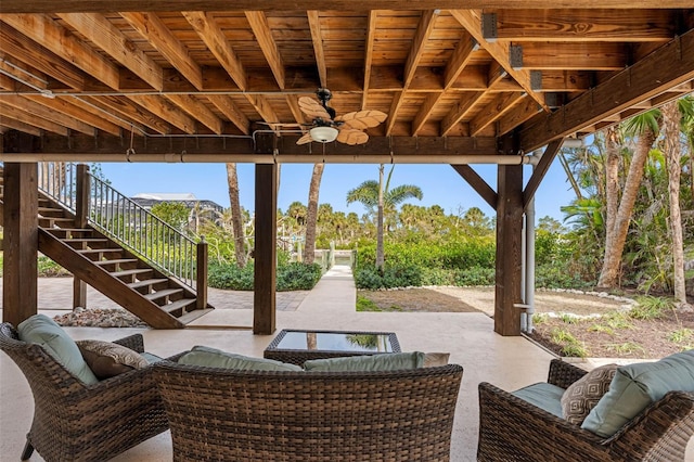 view of patio / terrace featuring ceiling fan, stairway, and an outdoor hangout area