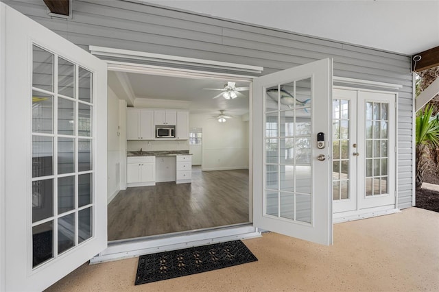 interior space with ceiling fan and french doors