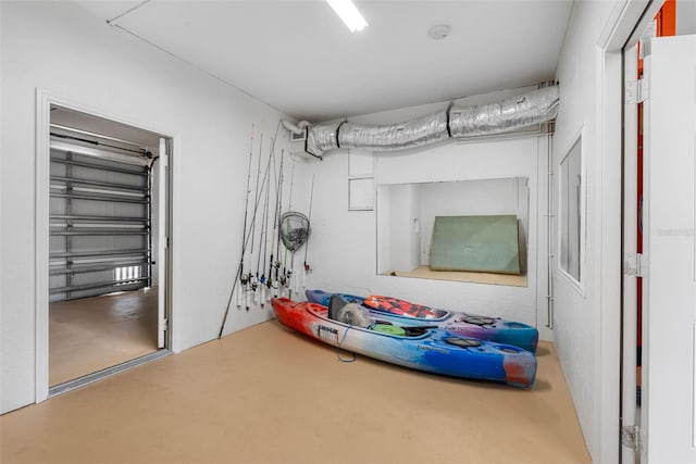 bedroom with concrete flooring and a garage