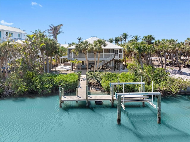 dock area with a water view, a patio, and stairway