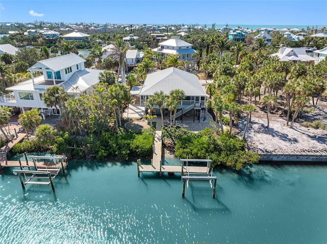 drone / aerial view featuring a water view and a residential view