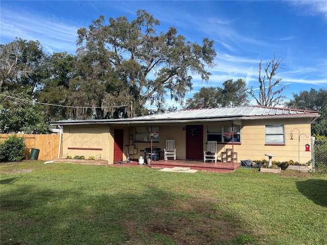 rear view of house with a yard