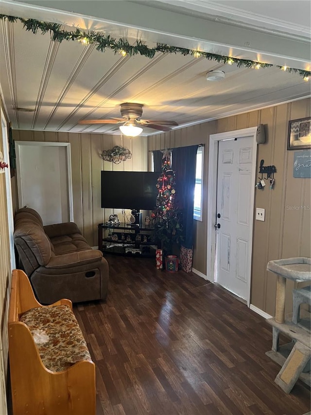 living room with ceiling fan and dark wood-type flooring