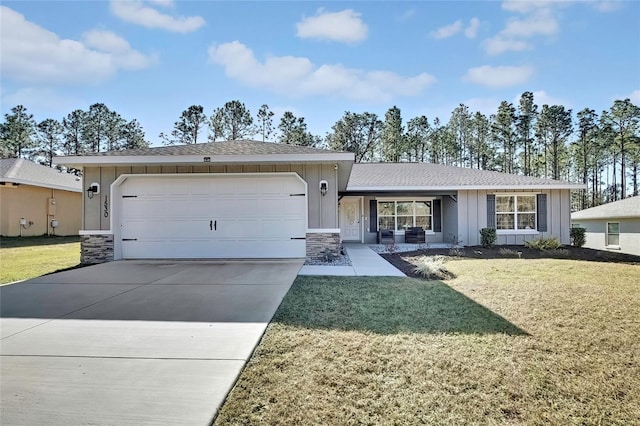 single story home with a garage and a front lawn