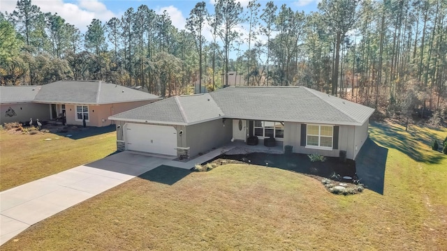 ranch-style home featuring a garage and a front lawn