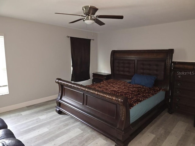 bedroom with light hardwood / wood-style flooring and ceiling fan