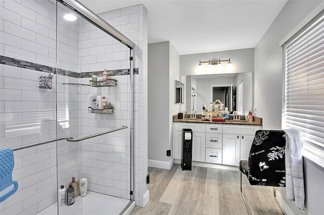 bathroom with vanity, hardwood / wood-style flooring, and an enclosed shower