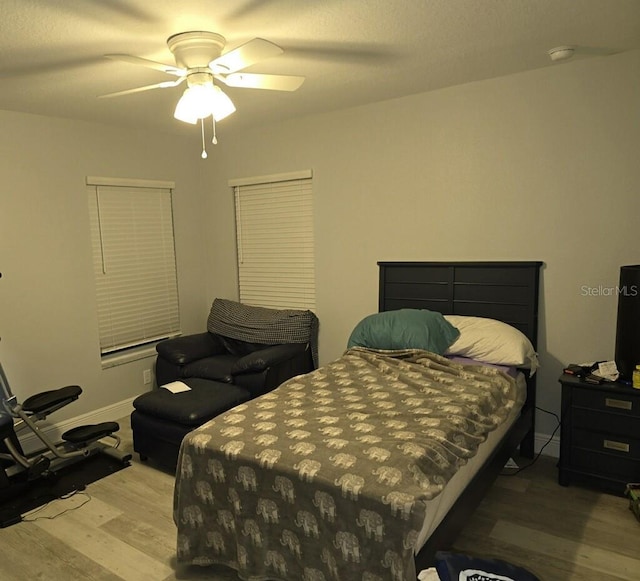 bedroom with light hardwood / wood-style flooring and ceiling fan