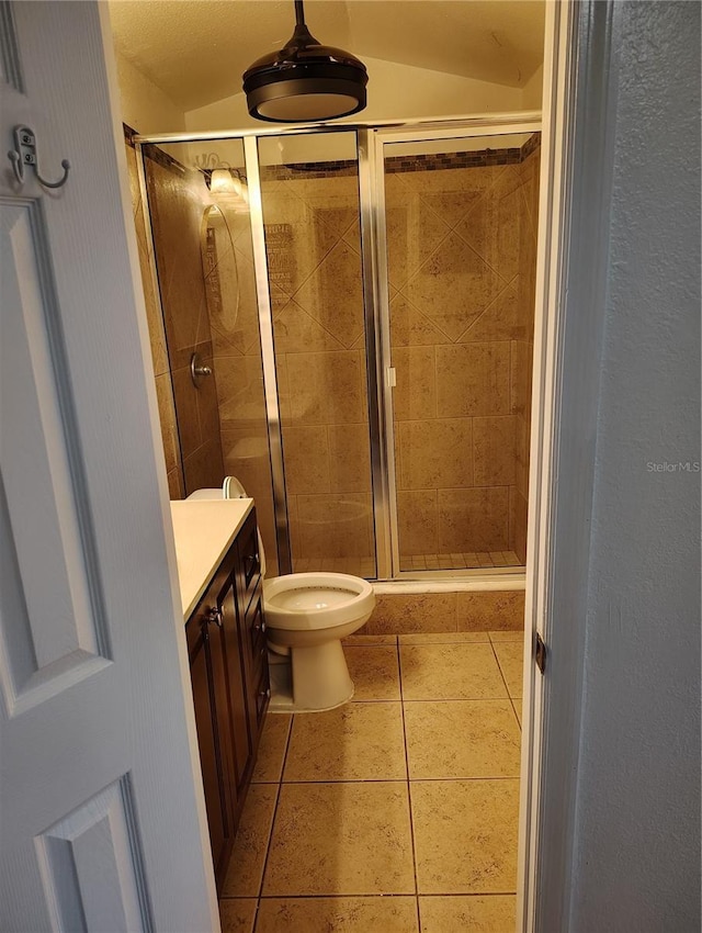 bathroom with toilet, tile patterned flooring, an enclosed shower, and vanity