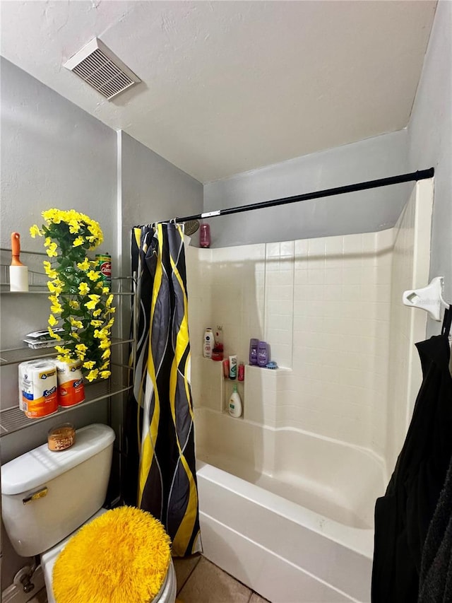 bathroom featuring tile patterned floors, shower / bath combo, and toilet