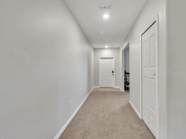 hallway with light colored carpet