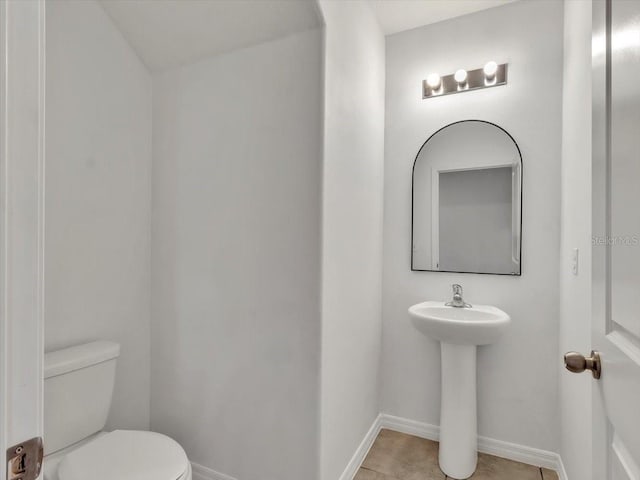 bathroom with tile patterned floors and toilet