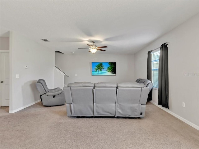 carpeted living room featuring ceiling fan