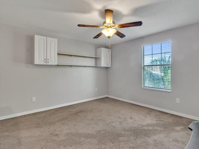 carpeted empty room with ceiling fan