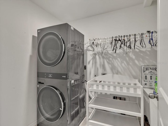 clothes washing area with stacked washer and clothes dryer