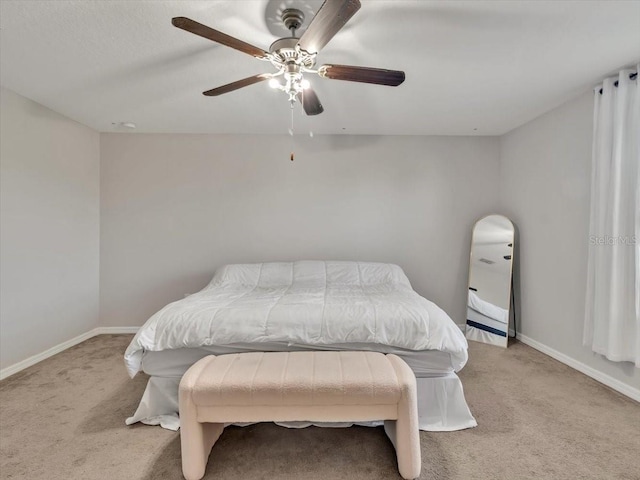 bedroom with light carpet and ceiling fan