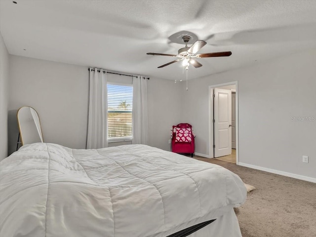 bedroom with light carpet, a textured ceiling, and ceiling fan