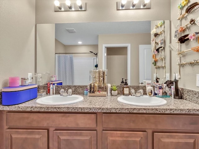 bathroom with vanity and a shower with shower curtain