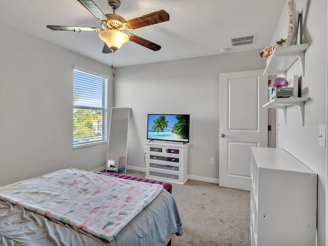 bedroom featuring light colored carpet and ceiling fan