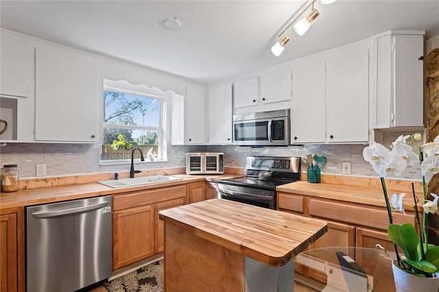 kitchen featuring white cabinetry, sink, and appliances with stainless steel finishes