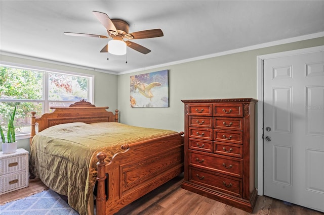 bedroom featuring wood-type flooring, ceiling fan, and ornamental molding