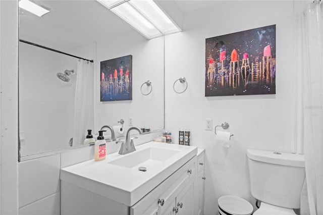 bathroom featuring vanity, toilet, and curtained shower