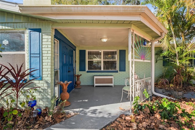 view of exterior entry featuring a porch