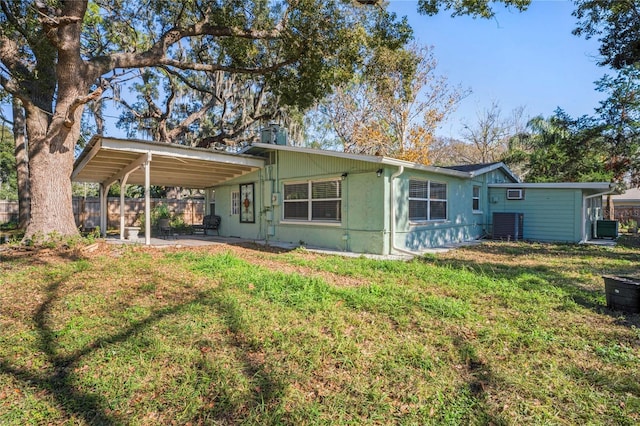 back of house with a patio area and a lawn