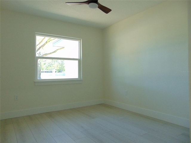 empty room with light wood-type flooring and ceiling fan