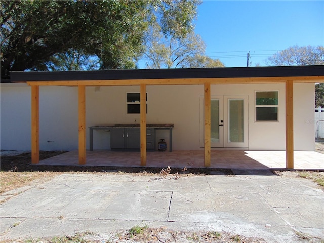 back of property with french doors and a patio