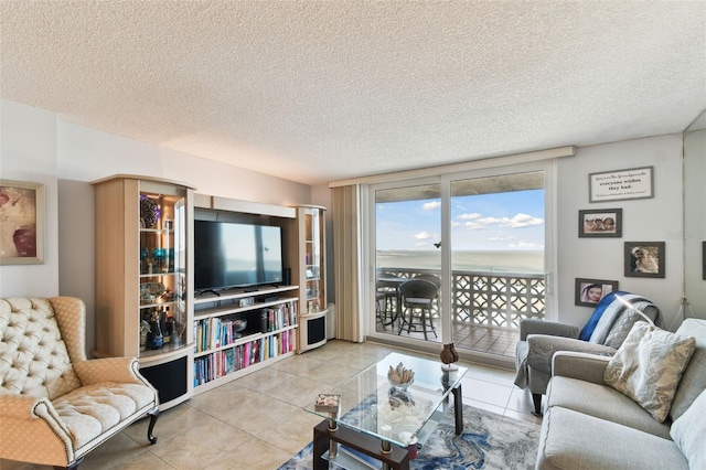 living room with light tile patterned floors and a textured ceiling