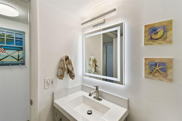 bathroom featuring vanity and a textured ceiling