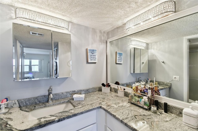 bathroom featuring vanity and a textured ceiling