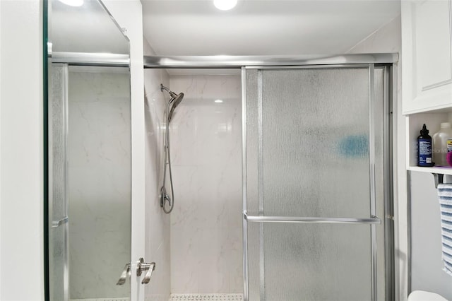 bathroom with a shower with shower door