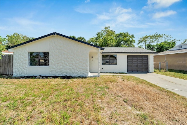 single story home with a front lawn and a garage