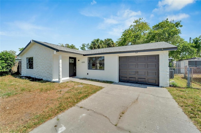 ranch-style house with a front yard and a garage