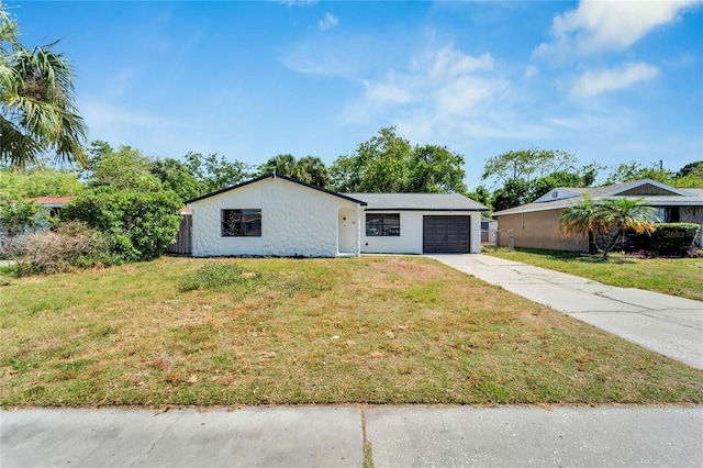 single story home featuring a garage and a front lawn