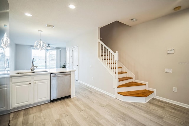 kitchen with pendant lighting, white cabinets, sink, stainless steel dishwasher, and ceiling fan