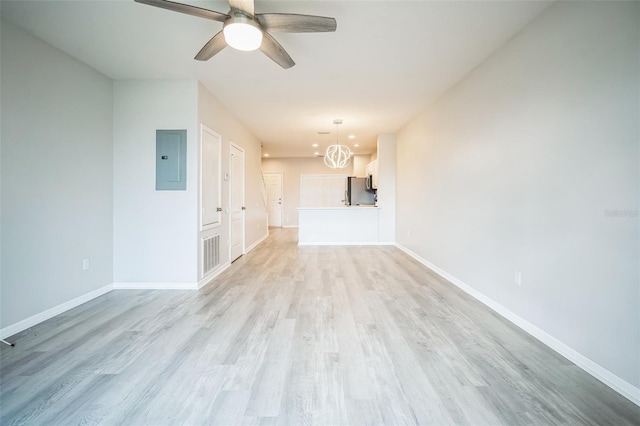 unfurnished living room with electric panel, light hardwood / wood-style floors, and ceiling fan with notable chandelier