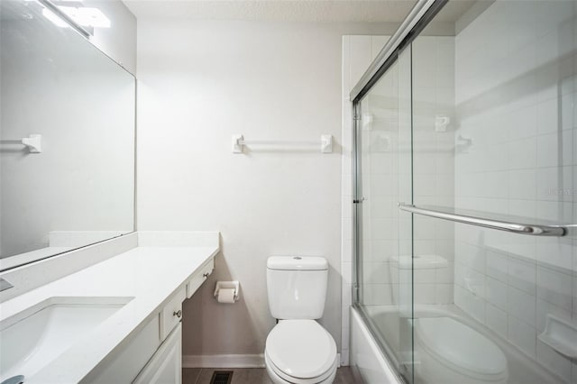 full bathroom featuring vanity, toilet, enclosed tub / shower combo, and a textured ceiling