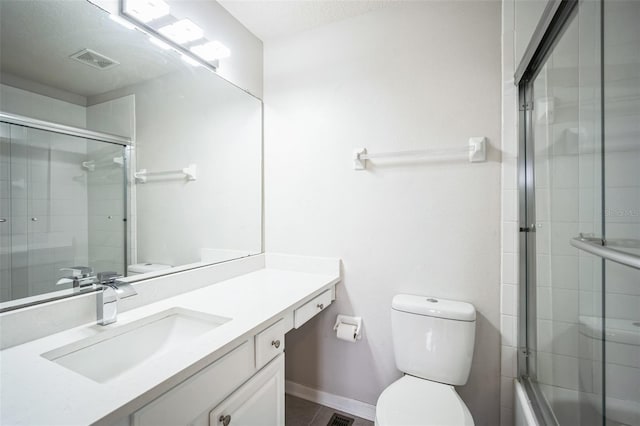 bathroom with vanity, toilet, and a textured ceiling