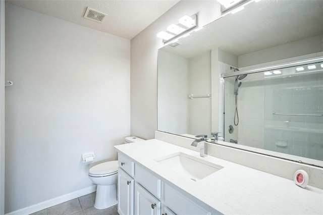 bathroom featuring tile patterned floors, an enclosed shower, a textured ceiling, vanity, and toilet