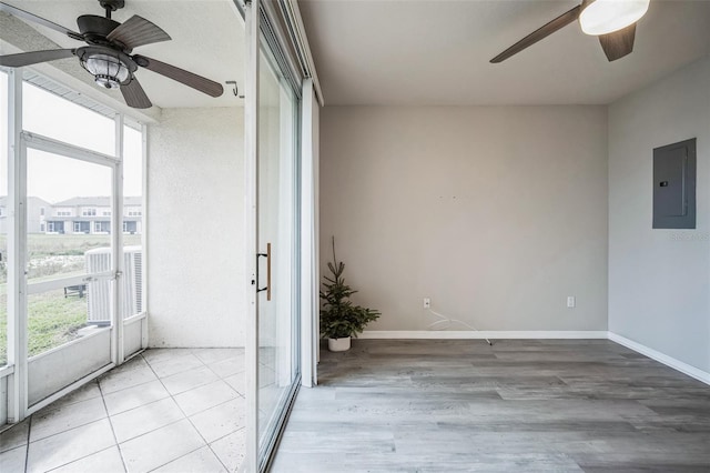 unfurnished sunroom with electric panel