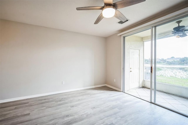 spare room featuring light hardwood / wood-style floors and ceiling fan